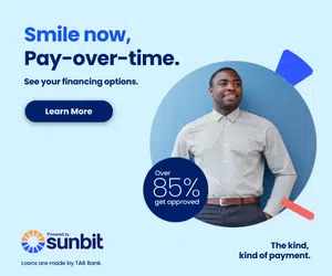 The image features a man standing against a blue background with a smiling expression, wearing a shirt and tie. He is positioned in front of a graphic design element consisting of a circular arrow pointing downwards towards a percentage sign indicating 85 . To his left, there s text that reads SMILE NOW, PAY-OVER-TIME, suggesting an advertisement for flexible payment options. Below this headline, there is additional text stating SEE YOUR FINANCING OPTIONS and a button labeled Learn more. The image also includes the logo of Sunbit at the top right corner.